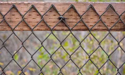 Things You Will Need to Cover a Chain Link Fence with Wood